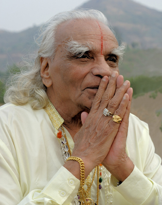 B.K.S. Iyengar in traditional prayer pose (namaste), showing the spiritual depth and reverence of the founder of Iyengar Yoga