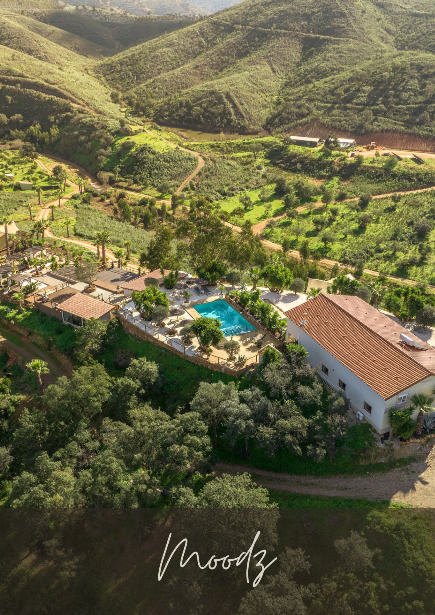 Aerial view of the Moodz Spa retreat villa and pool nestled in the green hills of Silves, Algarve