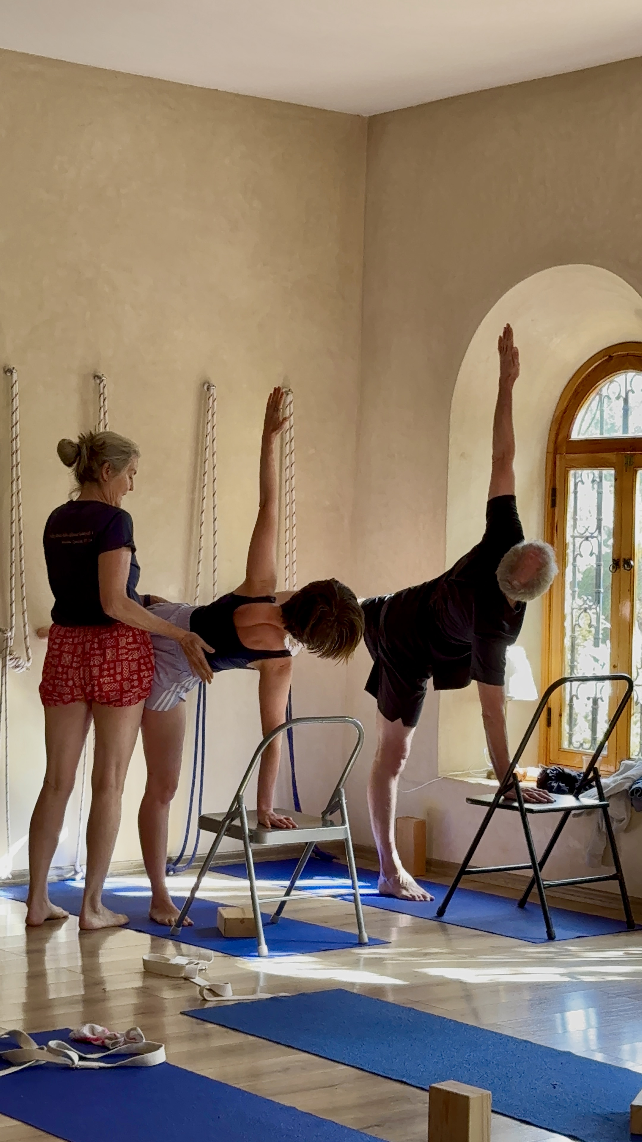 Students practicing chair yoga poses with instructor guidance at Bab Zouina yoga studio