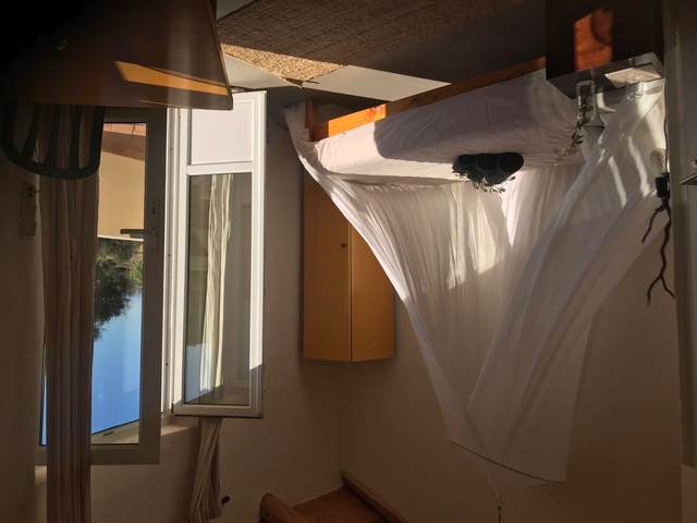 Serene bedroom with canopy bed and terrace doors at Casa Cales