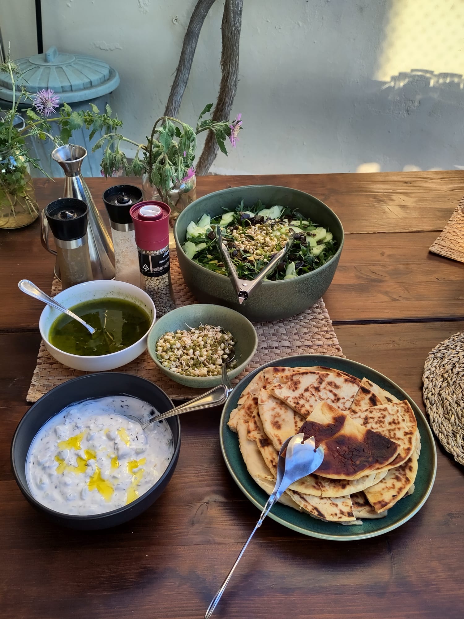 Delicious healthy vegetarian meal spread with fresh salad, flatbreads, and accompaniments at Casa Cales