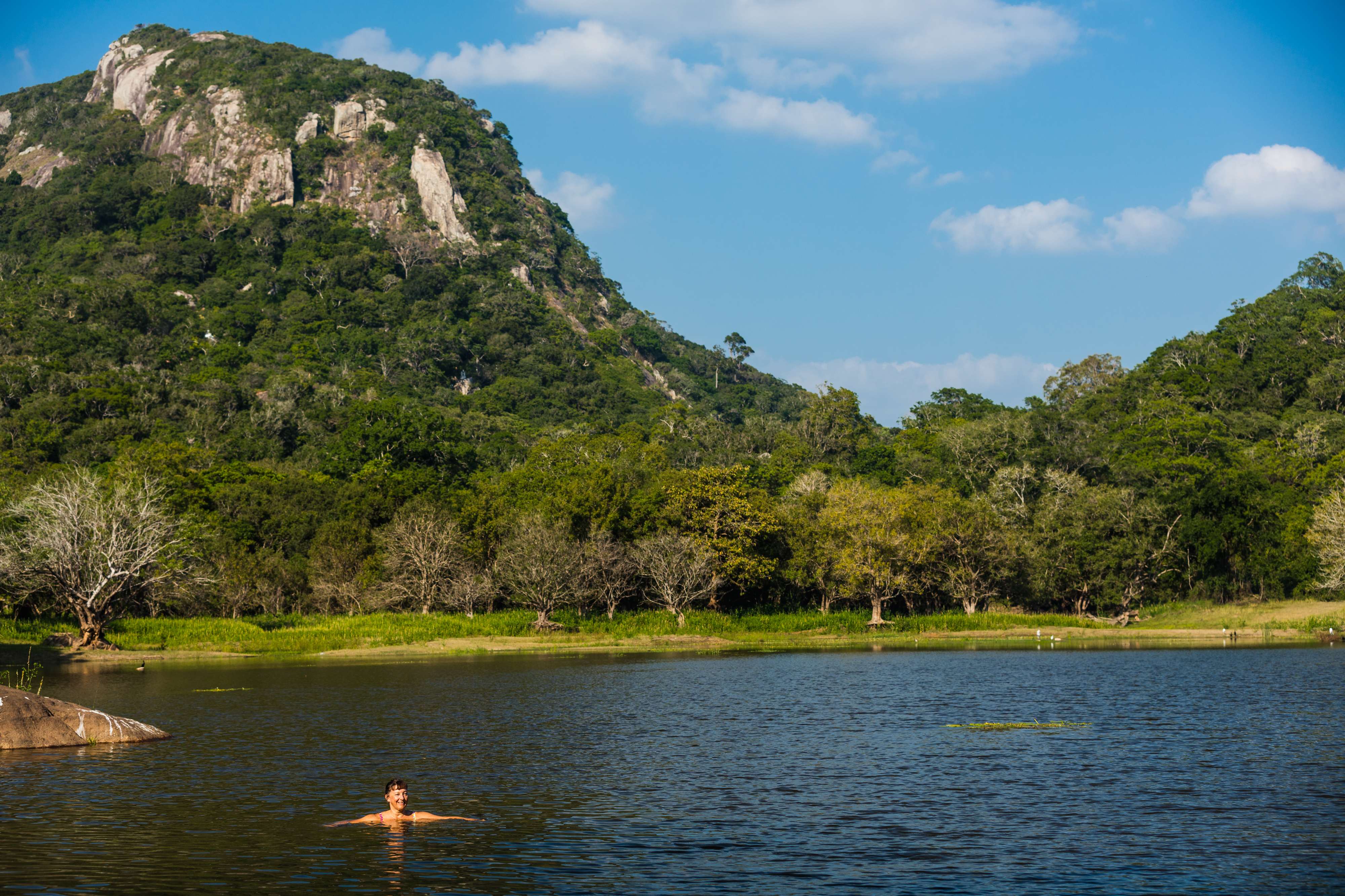 Natural swimming lake with dramatic mountain backdrop