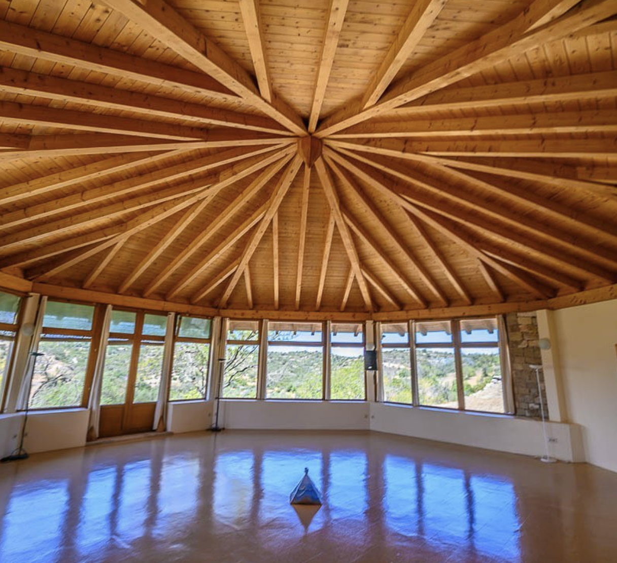 Beautiful yoga studio at Casa Cales with stunning radial wooden beam ceiling and panoramic windows