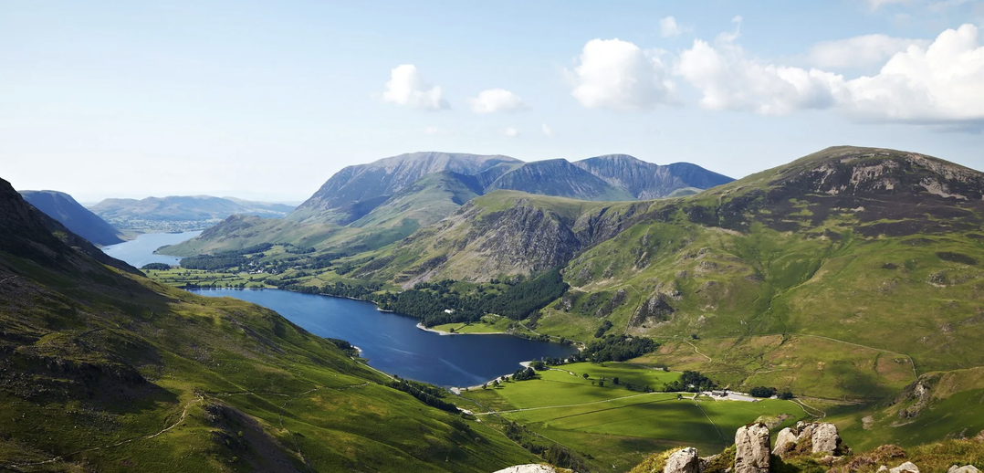 Panoramic view of Lake District fells and tarns from a mountain summit near Windermere