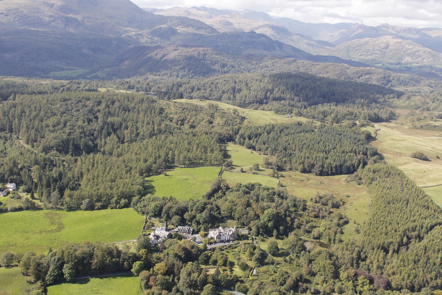 Aerial view of Yewfield retreat venue nestled in the Lake District mountains and forests